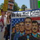 A banner references immigrants who serve in the U.S. military but face possible deportation during the Impeachment March on July 2, 2017 in Los Angeles, California. Image via Getty.